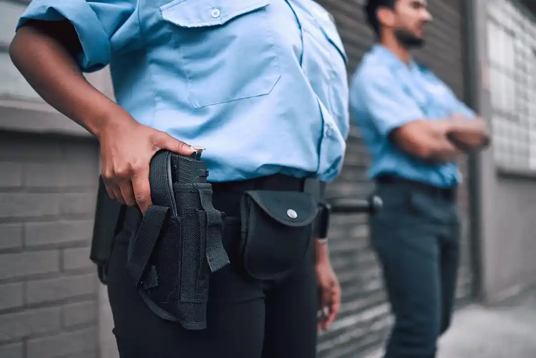 hand-gun-and-security-with-a-police-officer-on-du-2026-01-09-09-39-06-utc 1 hand-gun-and-security-with-a-police-officer-on-du-2026-01-09-09-39-06-utc 1